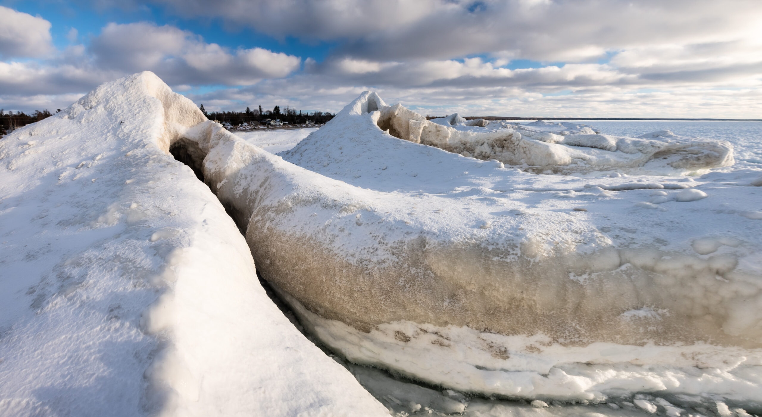 metres-tall snow peaks floating near the shore have large slits down the sides creating ice volcanoes