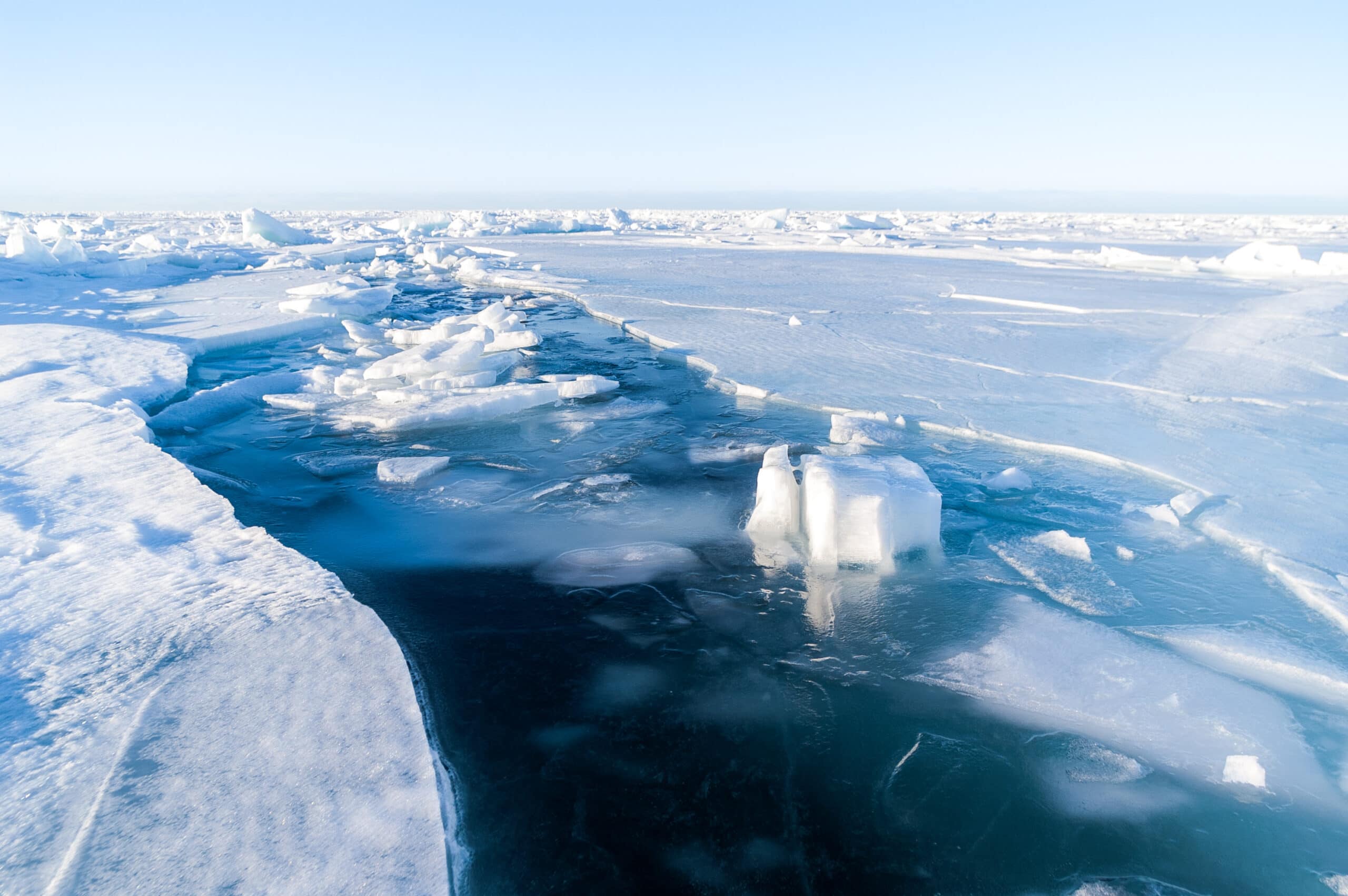 A bleed of open water cuts through the frozen bay.