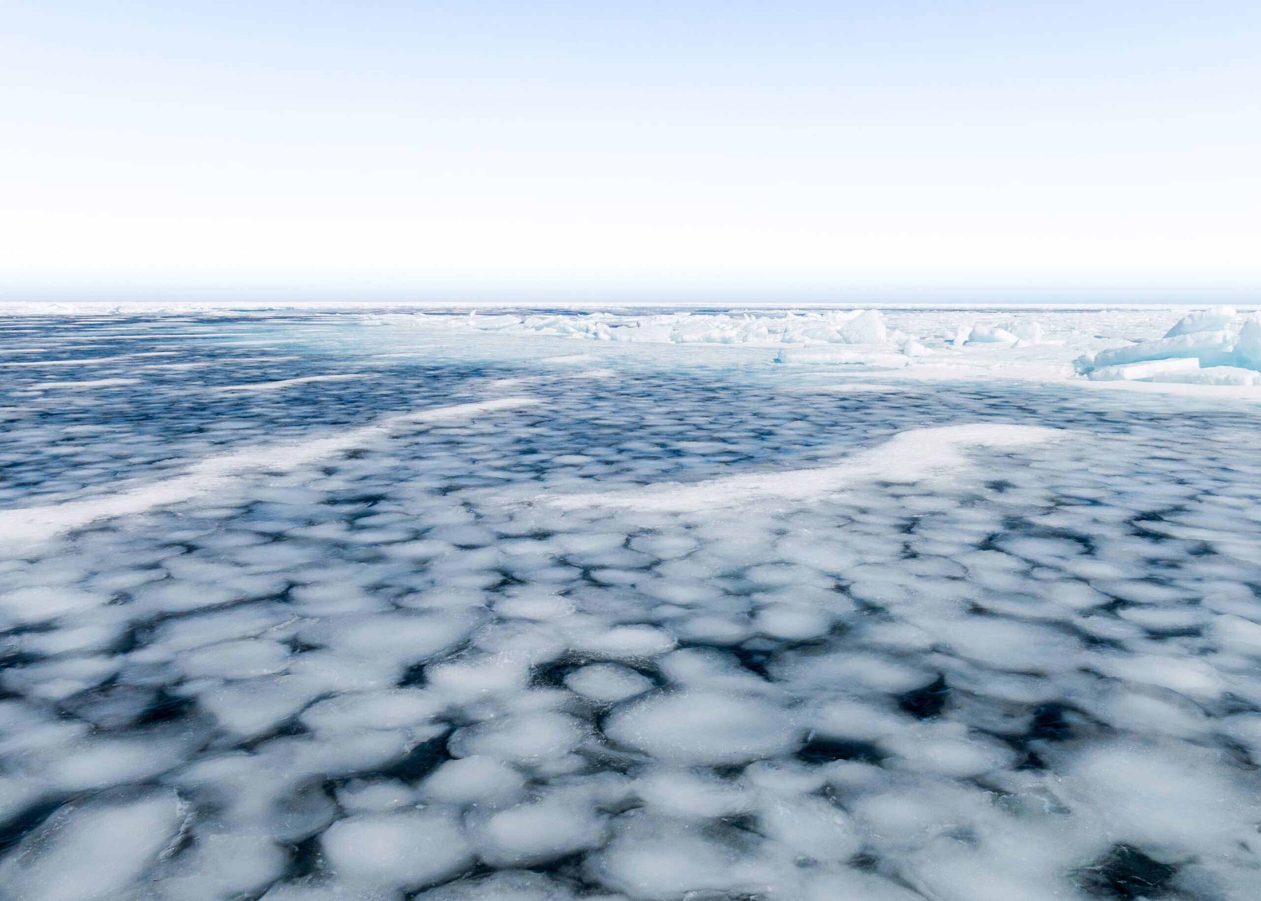 Circular disks of ice float on the bay.